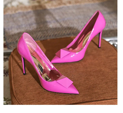 Women's pink pointed toe stiletto high heels with buckle closure and patent leather upper