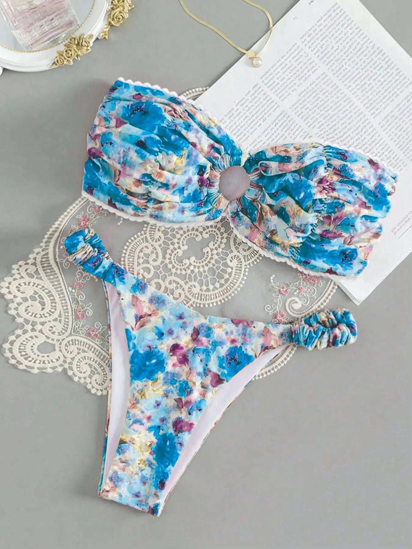 Colourful floral print tube top bikini set with lace trim on a mannequin