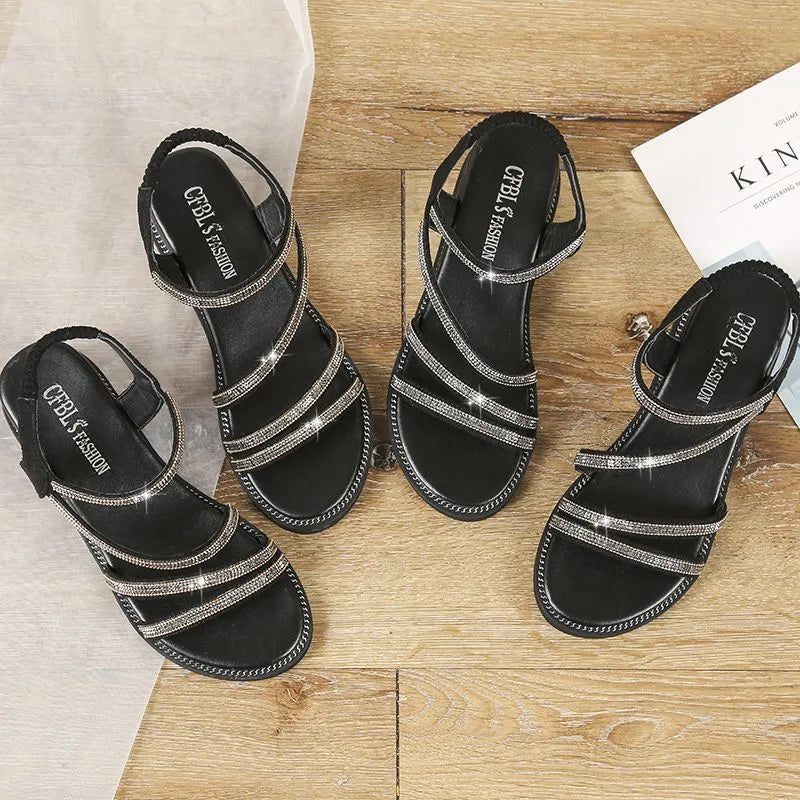 Women's silver sandals with elastic band and sequin accents, showing rubber sole and round toe design