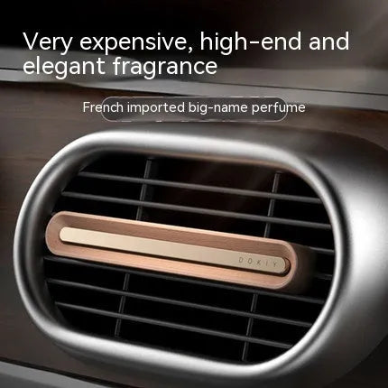 Car vent clip aromatherapy ornament in walnut or metallic grey with long strip design