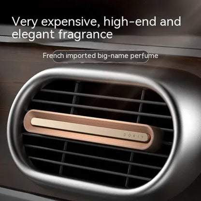 Car vent clip aromatherapy ornament in walnut or metallic grey with long strip design