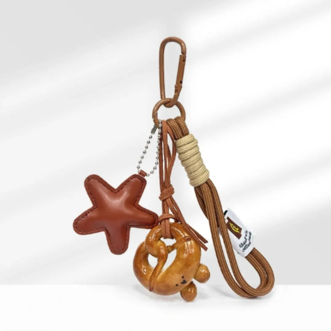 Handmade soda bread handbag pendant with cartoon croissant design on 30cm brown adjustable strap