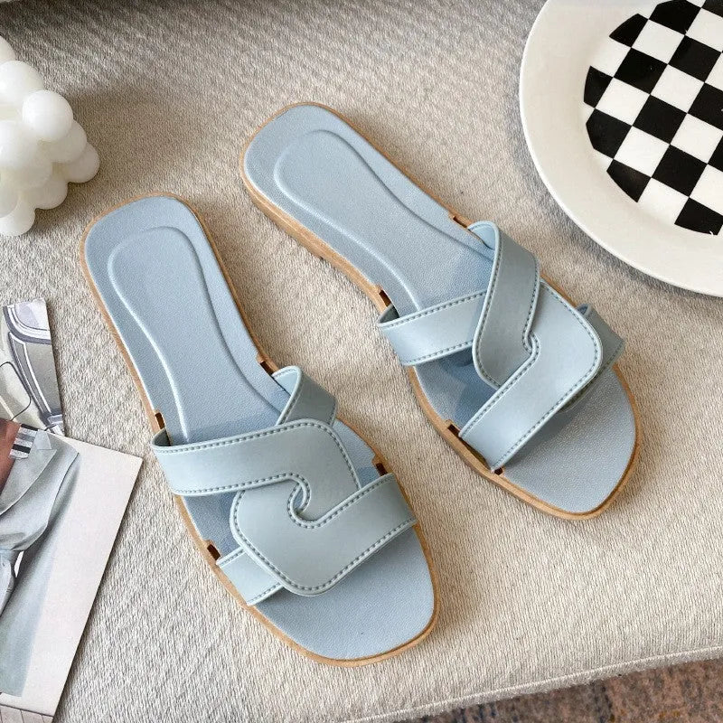 Women's PVC toe ring slippers with a cross strap in milky white, shown from a side angle.