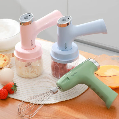 Pink electric whisk with stainless steel beaters showing 5-speed dial and compact 12cm housing