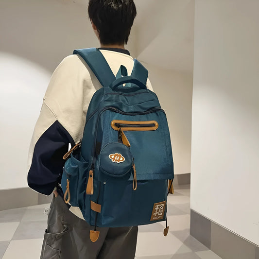 Large nylon school backpack for middle school students in a solid colour with curved shoulder straps.