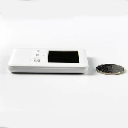 Black and white metal kitchen timer with magnetic back on a refrigerator door