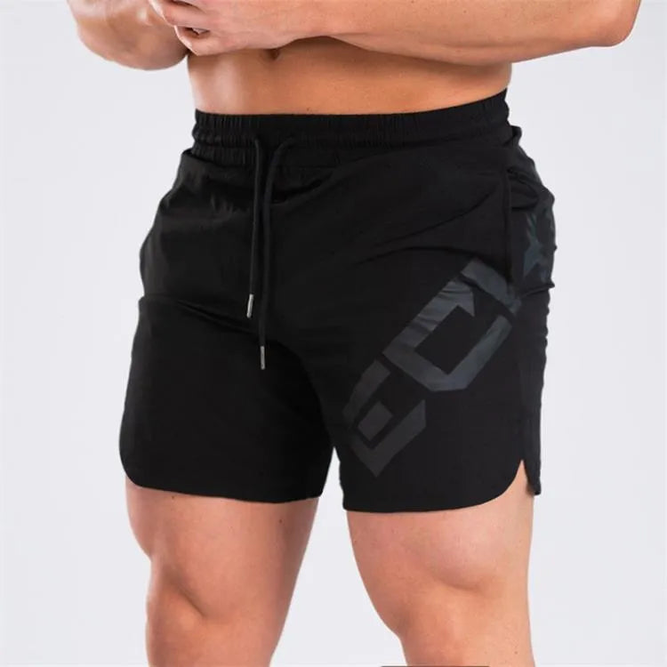 Men's black quick-dry training shorts with elastic waistband, shown knee-length.