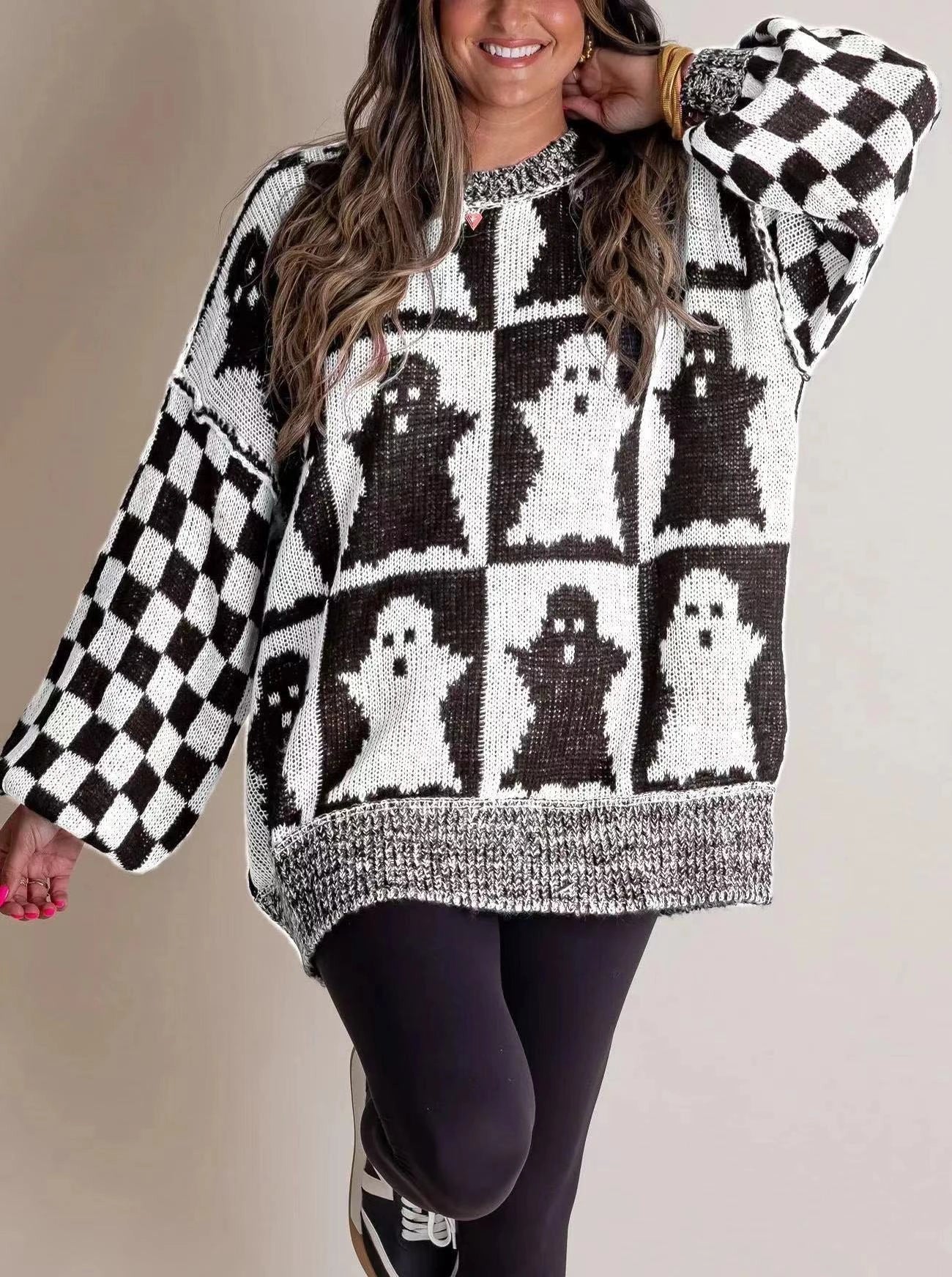 A stylish Halloween sweater featuring a unique pumpkin and ghost graphic design, available in a variety of fashion-forward colors.
