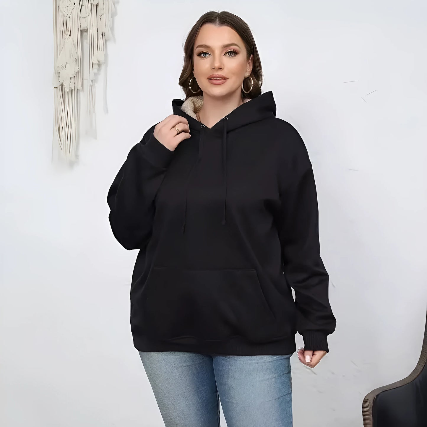 Women's loose fit hooded sweater in thick grey polyester fleece with 3D pattern and front pockets.