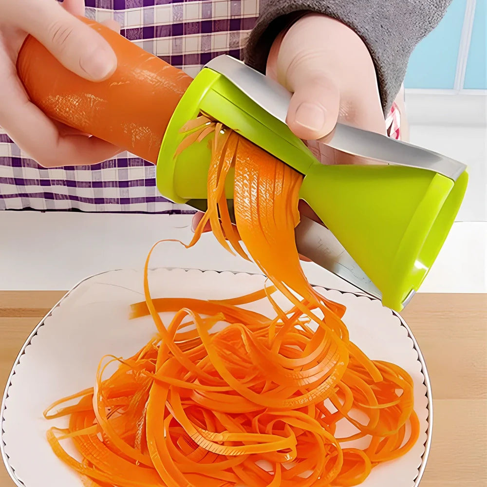 White spiral vegetable slicer with stainless steel blades on kitchen counter with zucchini noodles