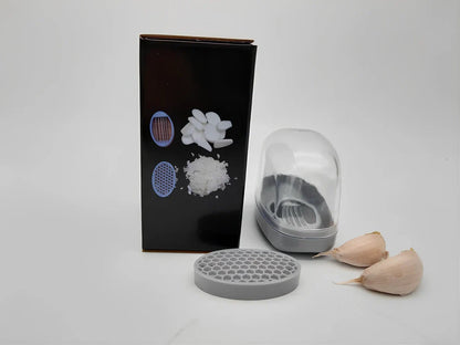 White plastic garlic cutter with stainless steel blades measuring 11cm long