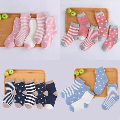 A group of colorful cotton tube socks in various sizes and patterns, designed for children's comfort and style.