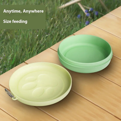 Collapsible silicone dog bowl with integrated snack compartment in light pink colour