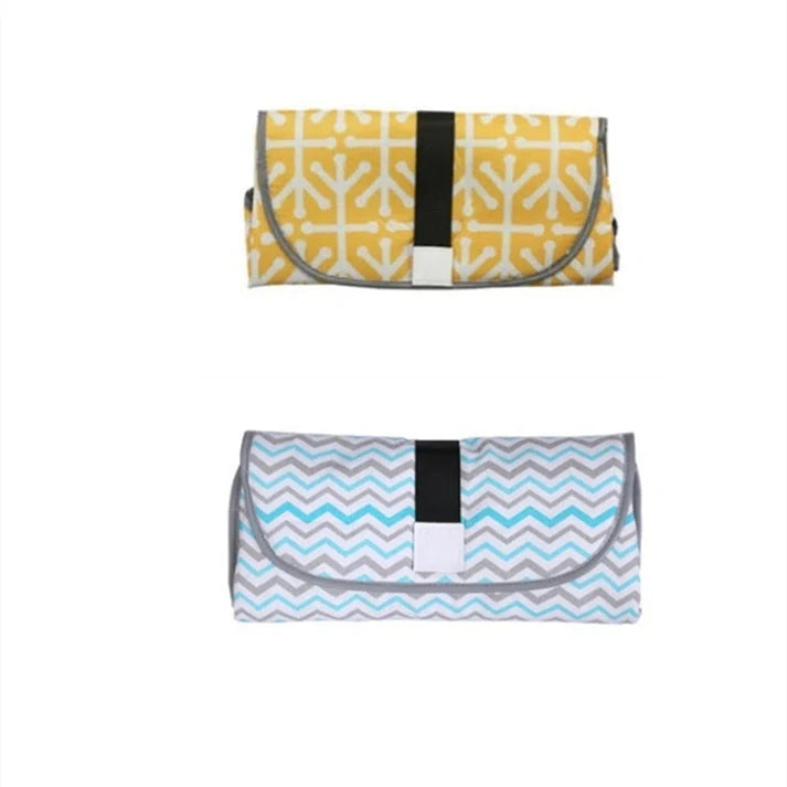 Portable and Waterproof Baby Changing Pad in various color designs, featuring a compact folded size and generous expanded size for comfortable diaper changes