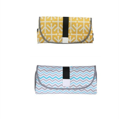 Portable and Waterproof Baby Changing Pad in various color designs, featuring a compact folded size and generous expanded size for comfortable diaper changes