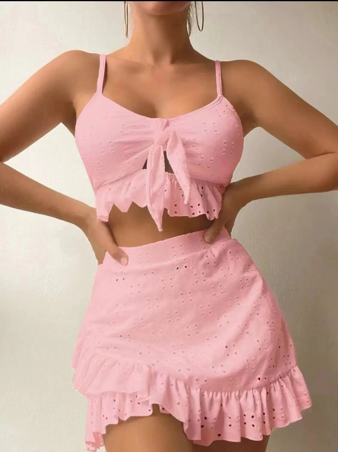 Women's white split hip skirt three-piece bikini swimsuit set on a mannequin.