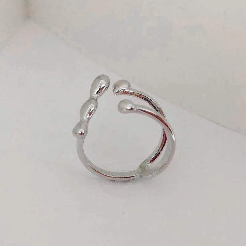Gold and silver adjustable brass ring featuring a large spherical design on an open shank.