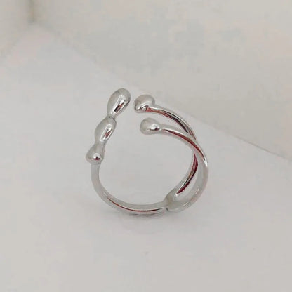 Gold and silver adjustable brass ring featuring a large spherical design on an open shank.