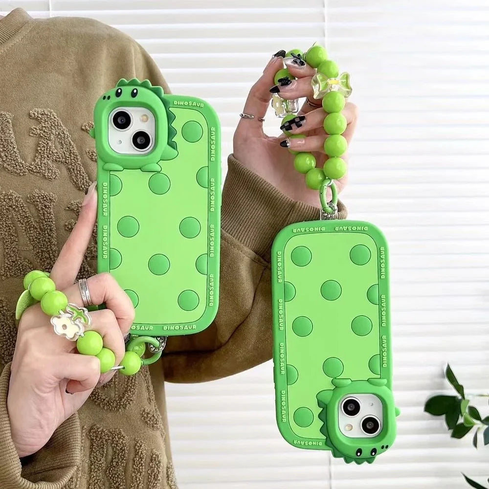 Green polka dot dinosaur silicone phone case showing back design and side protection for iPhone