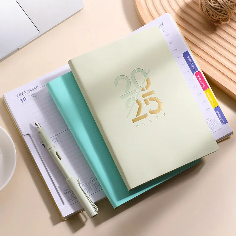 A5 daily planner with faux leather cover in blue, showing open pages and bound spine.
