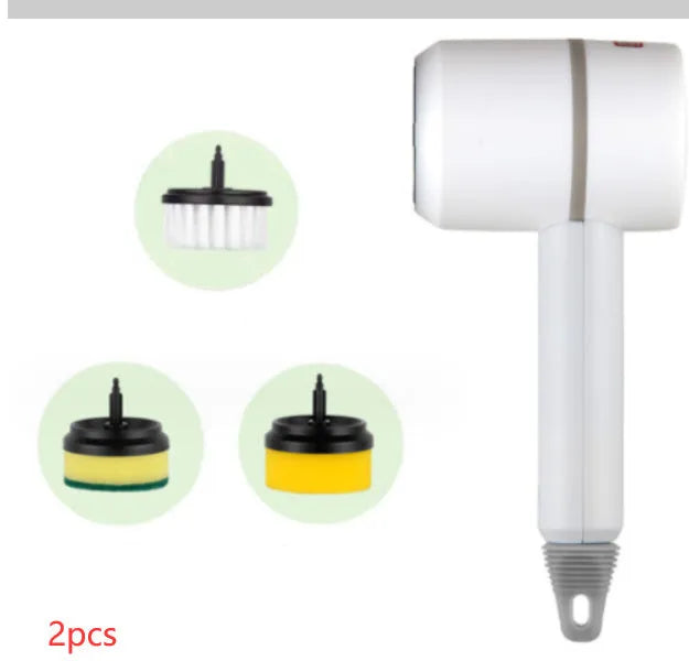 Green electric cleaning brush with scouring pad and brush heads on a kitchen worktop.