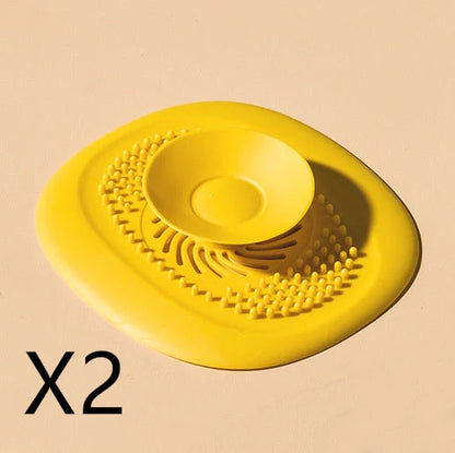 TPR vortex design sink drain cover in twilight orange, quiet blue, mango yellow, and gentian green