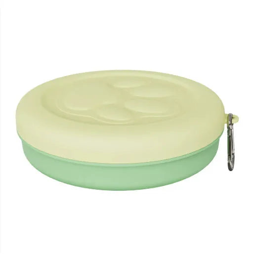 Collapsible silicone dog bowl with integrated snack compartment in light pink colour