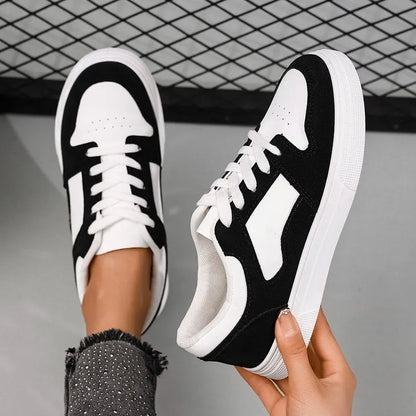 Black women's low-top lace-up casual sports shoes with a round toe and flat rubber sole.