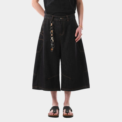 Men's black retro washed denim cropped pants with straight legs and side pockets laid flat