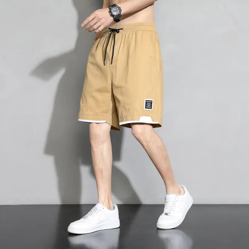 Cotton shorts for teenage boys in black, shown on a hanger, featuring a mid-waist design.