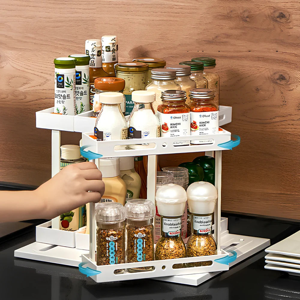 Pull-out spice rack installed under kitchen sink with spices organised in plastic drawer