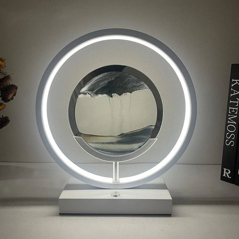 Creative minimalist quicksand table lamp with adjustable three-colour LED lighting on wooden surface