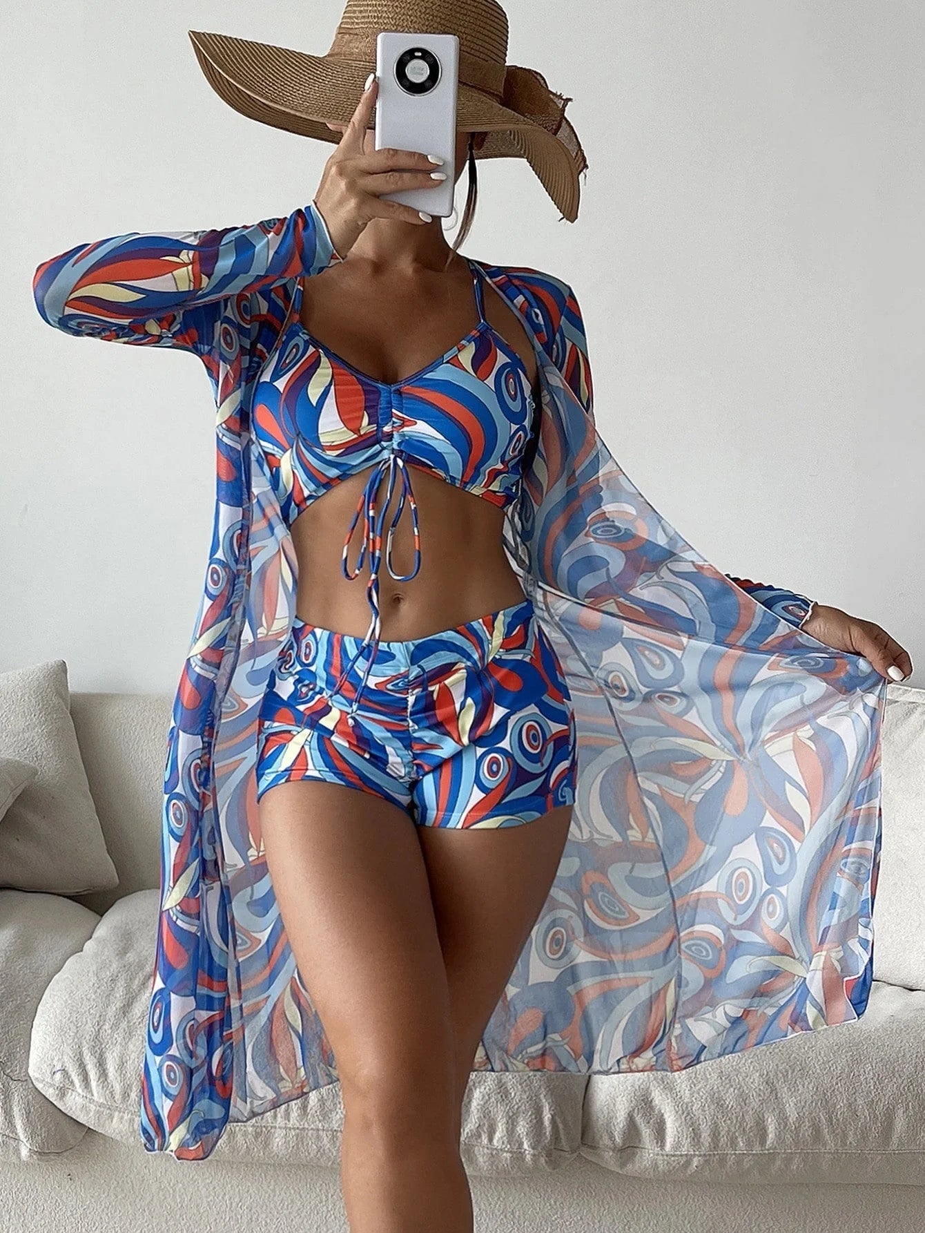 Women's floral print bikini set with long sleeve cardigan for summer beach outings