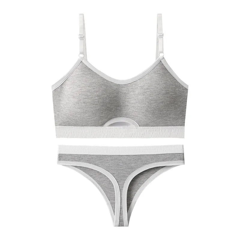 White sports bra and briefs set with thin moulded cups and double shoulder straps on a grey background.