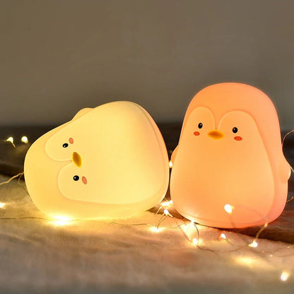 Penguin-shaped night light with soft white LED illumination and USB charging port