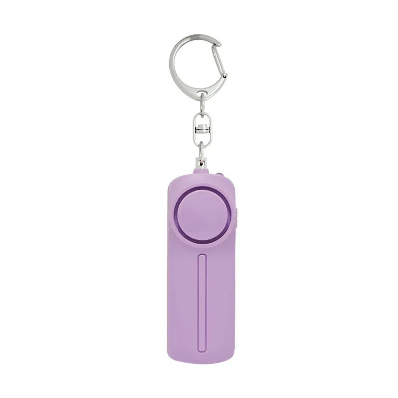Compact pink self-defense alarm showing 86mm length with activation button and LED light