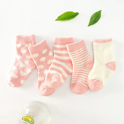 A group of colorful cotton tube socks in various sizes and patterns, designed for children's comfort and style.