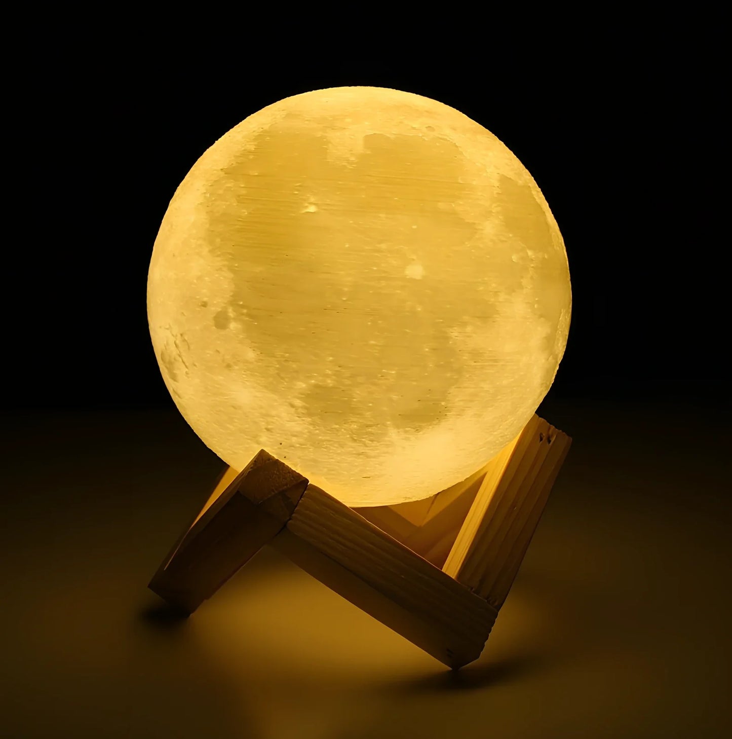 3D printed moon night light with detailed lunar surface and dual-colour LED lighting on beech wood stand