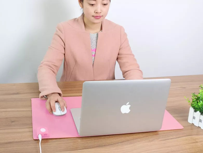 Two-stage Heating Desk Pad in black or pink, featuring quick warmth and waterproof design