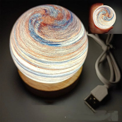 Planet-shaped USB night light with adjustable dimming in 12 colour options on its base.