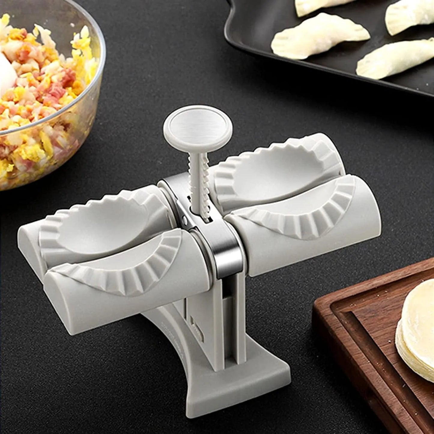 White double-head manual dumpling maker press on a kitchen counter