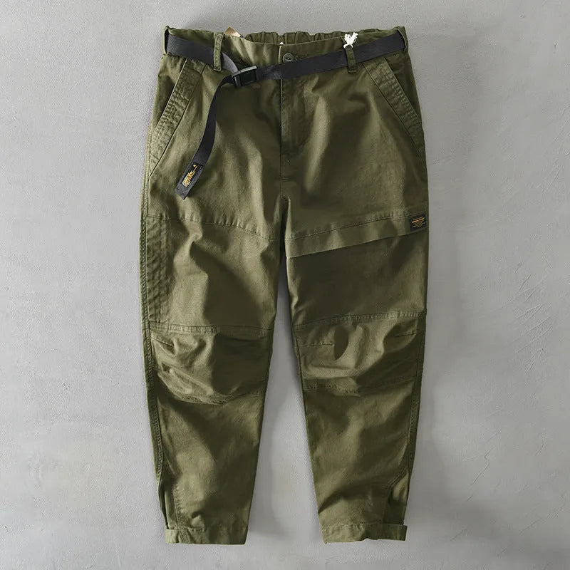 Man wearing khaki-coloured loose-fit cotton casual overalls with an elastic waist.