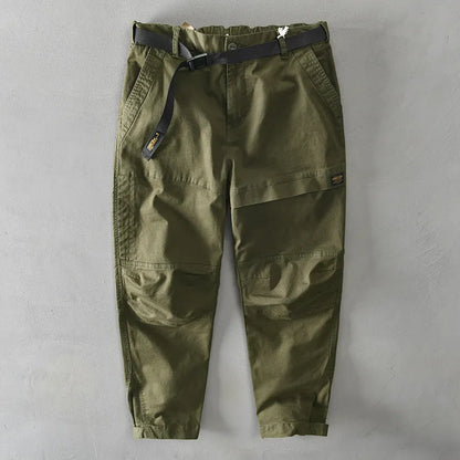 Man wearing khaki-coloured loose-fit cotton casual overalls with an elastic waist.