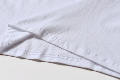 White cotton pullover overalls with a pattern, short sleeves, and a round neck on a teenager.