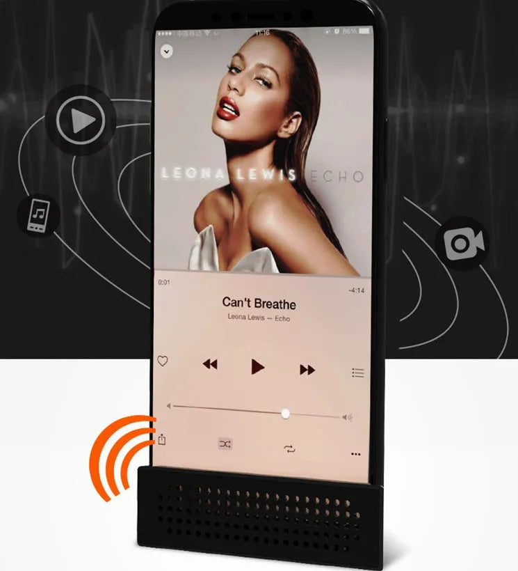 Portable black ABS plastic phone amplifier bracket holding a smartphone on a desk.