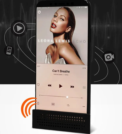 Portable black ABS plastic phone amplifier bracket holding a smartphone on a desk.
