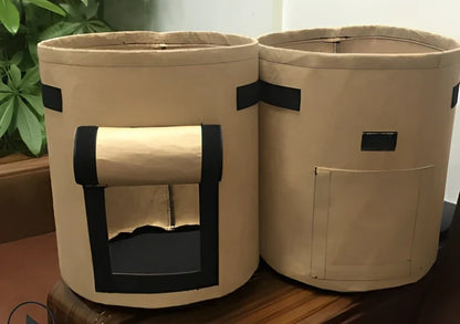 Black plant growth bag with side harvesting window and double handles for potato gardening