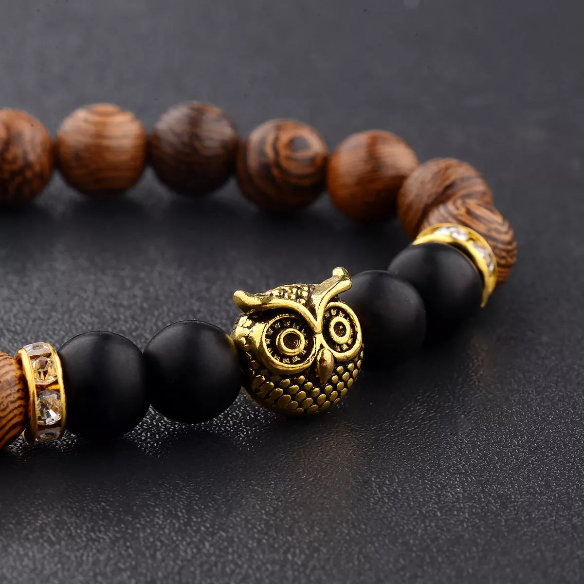 Owl frosted stone lifeline wood grain bracelet in black and gold, featuring wood beads and alloy stone