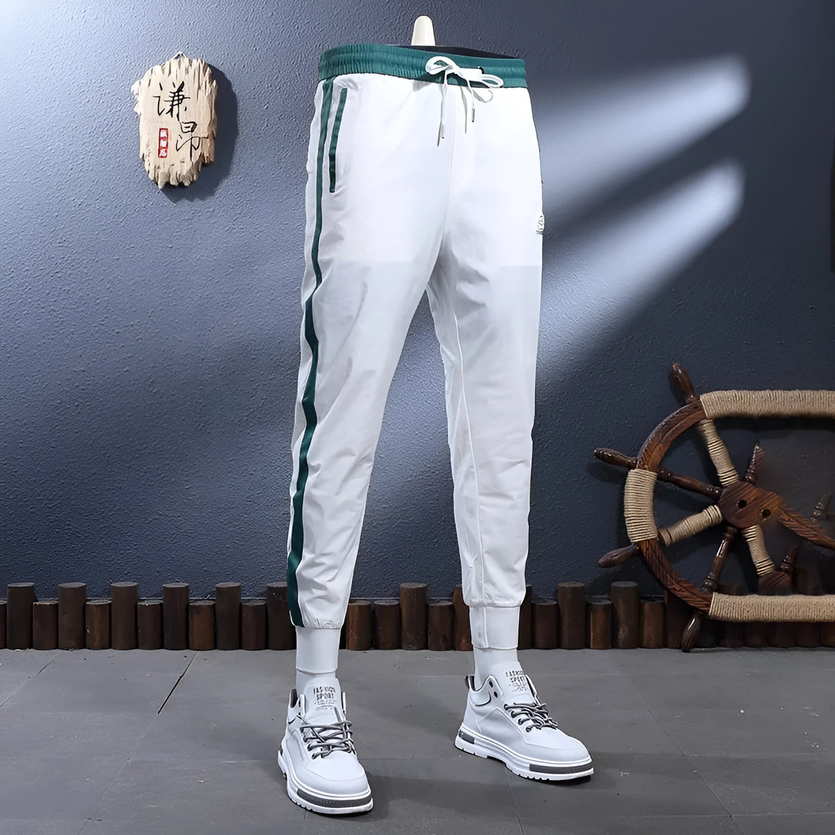 Men's ice silk skinny sports pants in black or white with striped tapered leg and ankle-tied hem