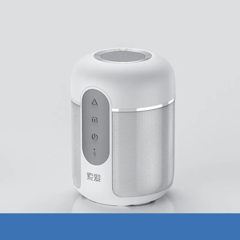 Small black portable Bluetooth speaker showing front grille and control buttons on a table.